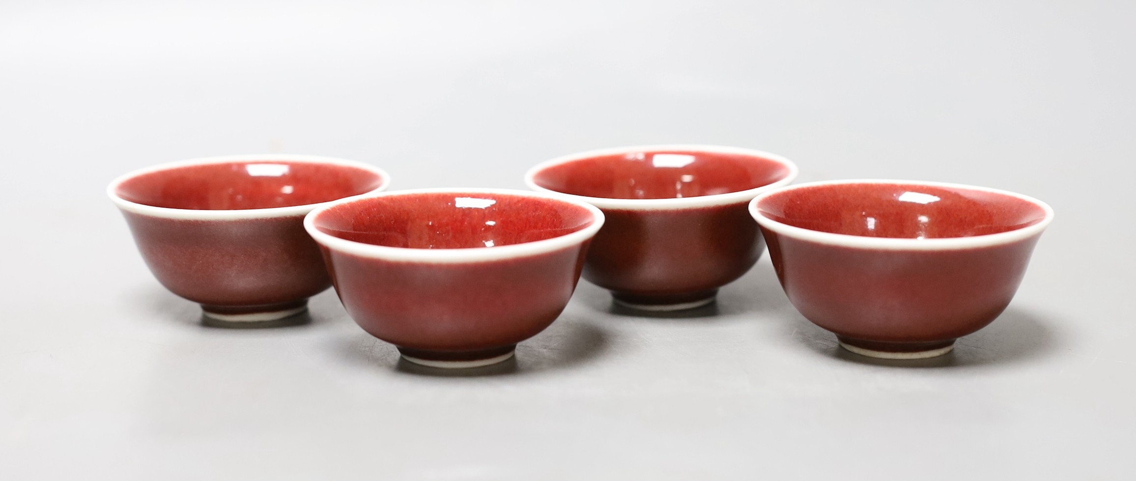 A set of four Chinese ox blood bowls, marks to base, 3.5cm high